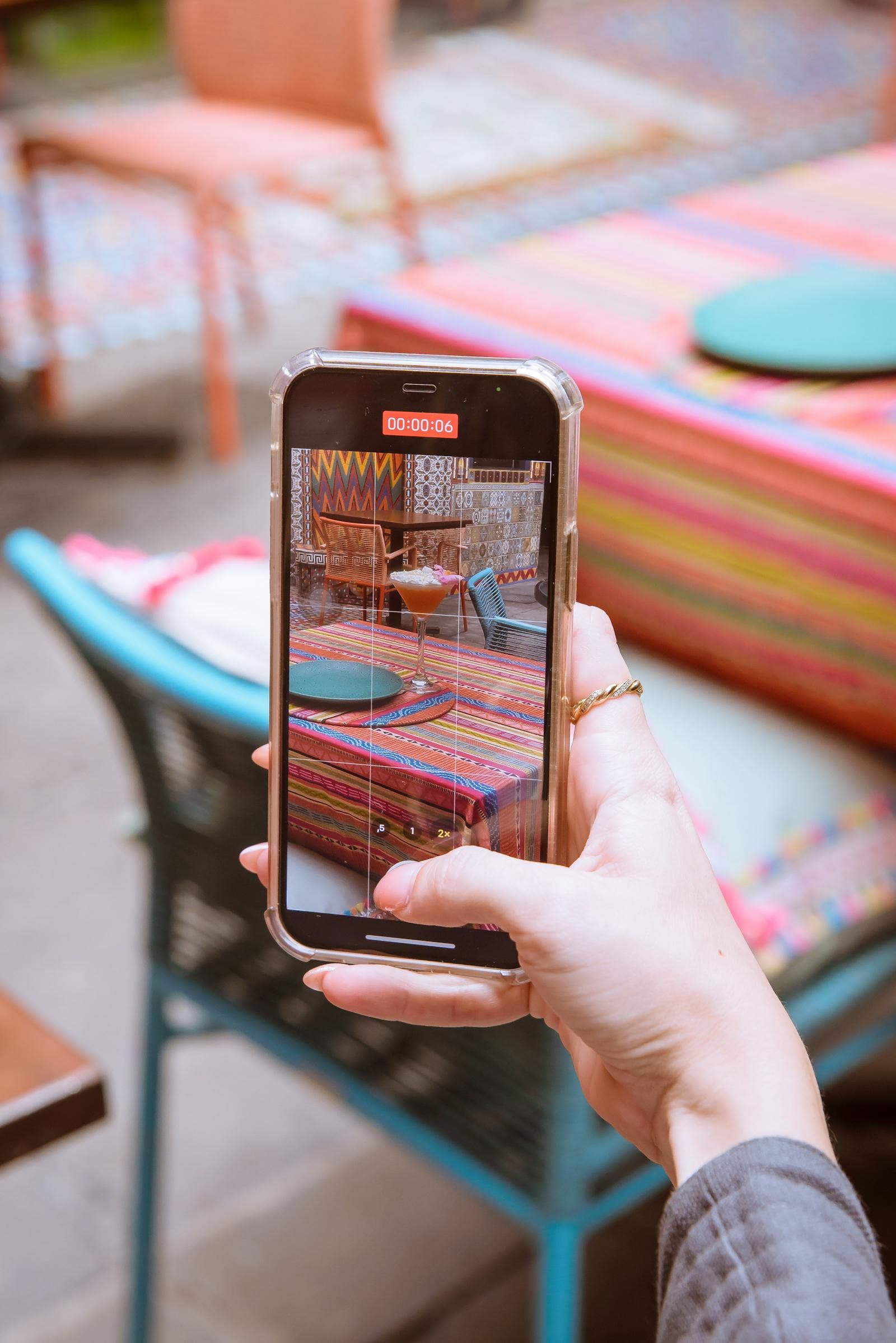 Smartphone taking a photo of a drink on a table