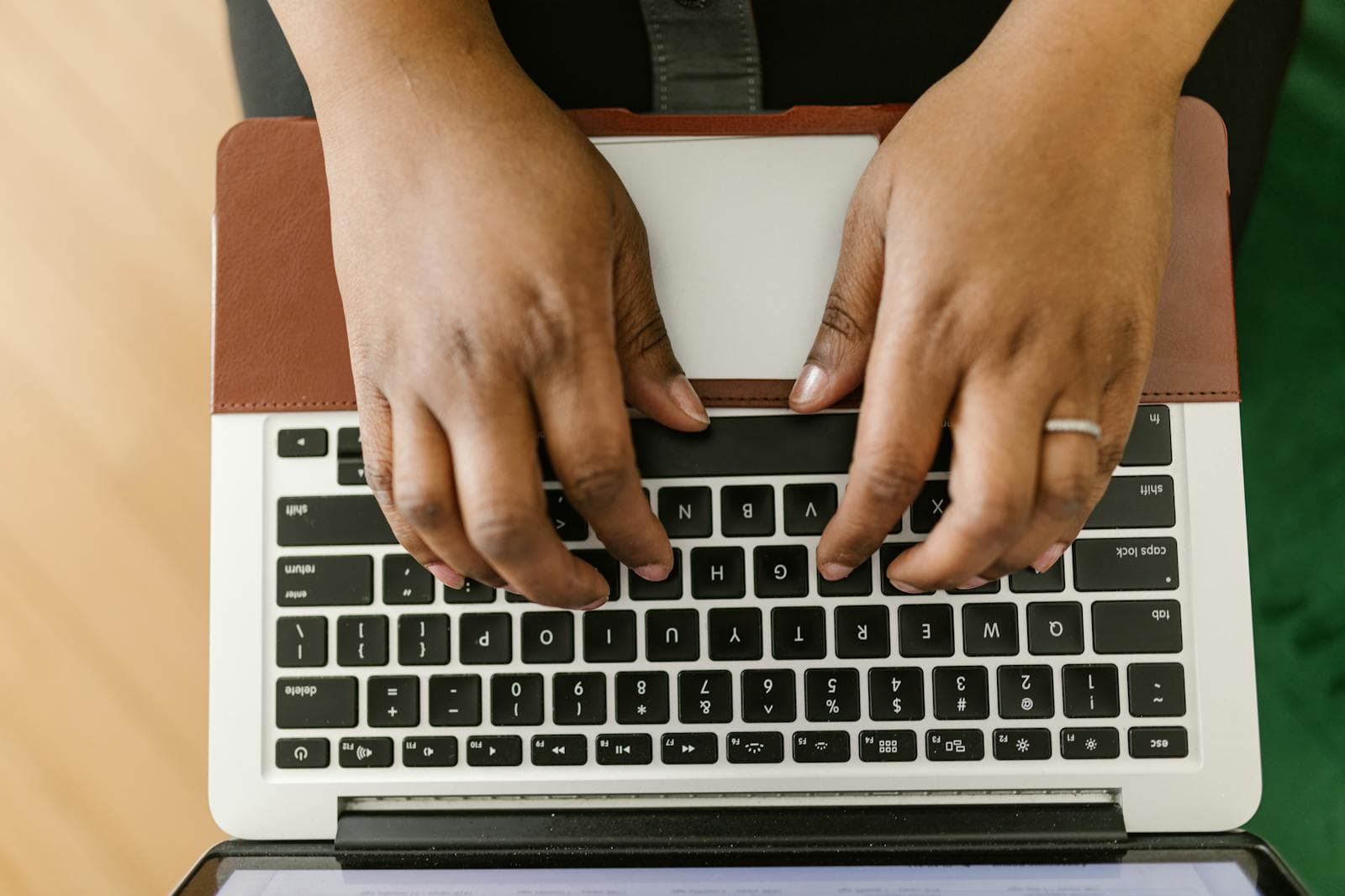 Hands typing on a laptop keyboard